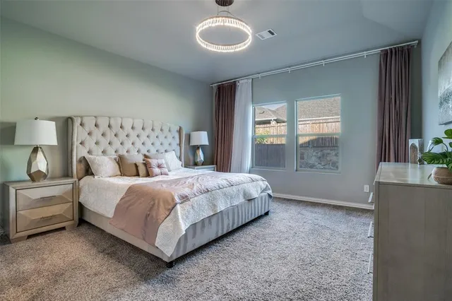 a large bed sitting in a bedroom next to a window