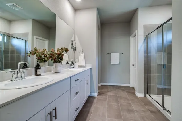 a bathroom with a double vanity sink and mirror