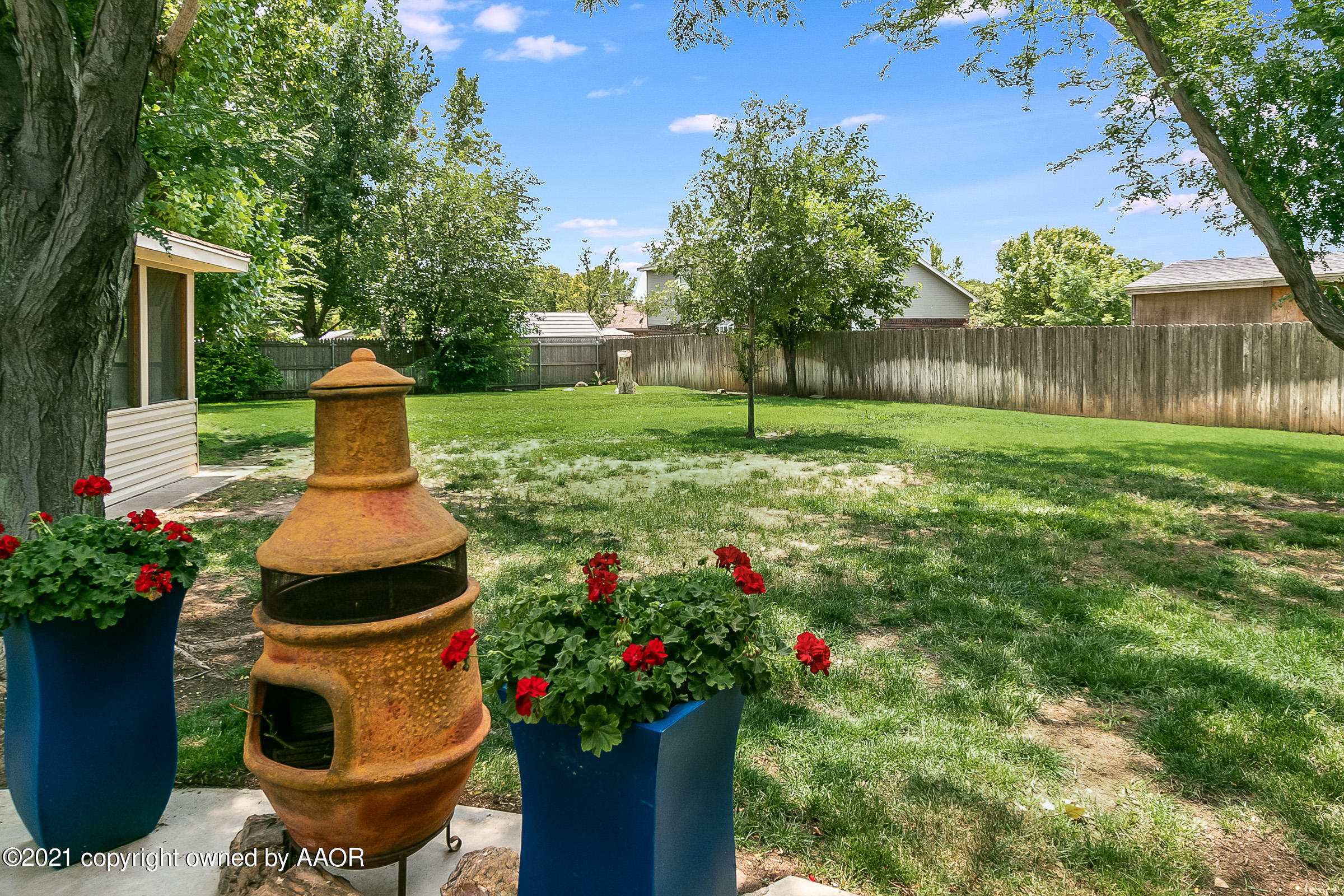 8300 Ranier Drive Amarillo, TX 79110 - Photo 25 of 27 a front view of a house with a yard and fountain