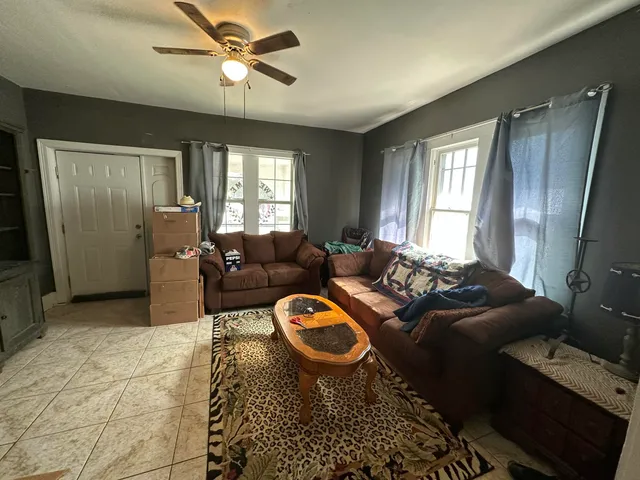 a living room with furniture and a fireplace