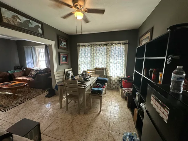 a living room with lots of furniture and a window