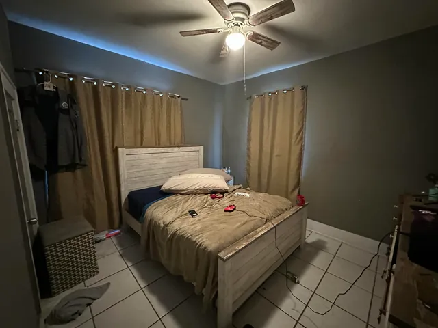 a bed sitting in a bedroom next to a window