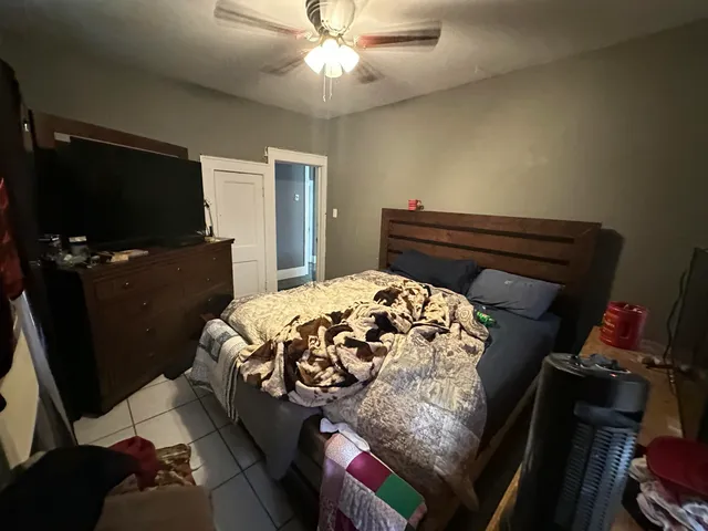 a bedroom with a bed and a flat screen tv