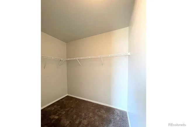 an empty room with a window and a livingroom