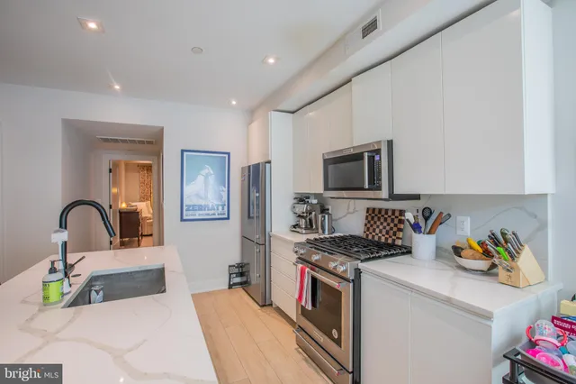 a kitchen with a microwave a stove and cabinets