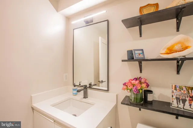 a bathroom with a sink vanity and a mirror