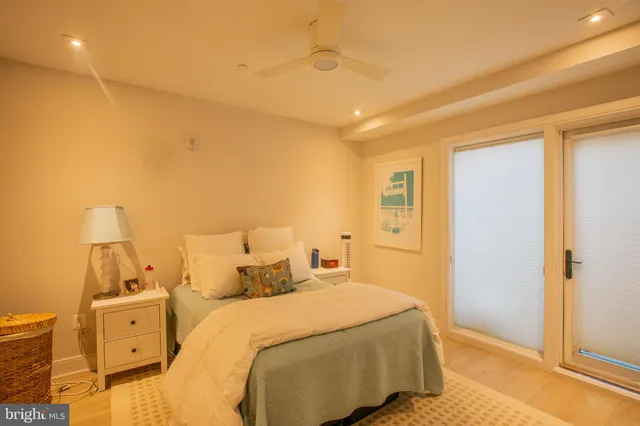 a bedroom with a bed and a night stand