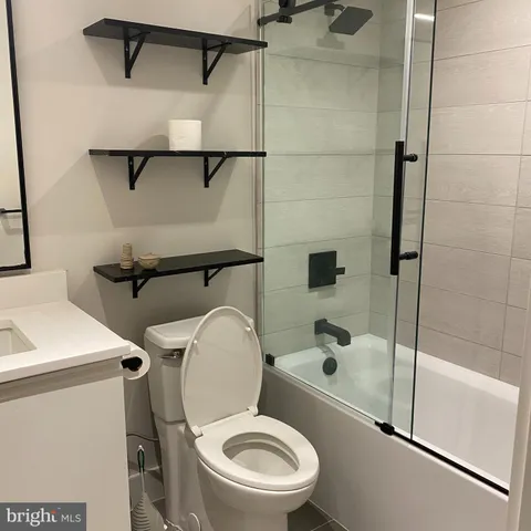 a white toilet sitting next to a bath tub