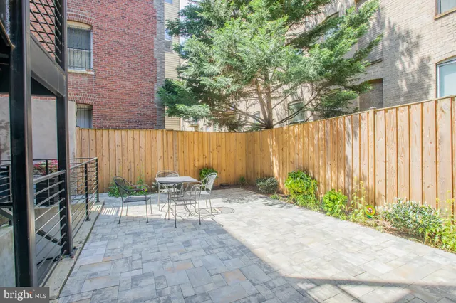 a view of backyard with outdoor seating and green space