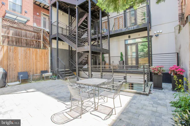 a view of a patio with table and chairs and potted plants