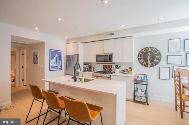 a view of a dining room with furniture and a kitchen