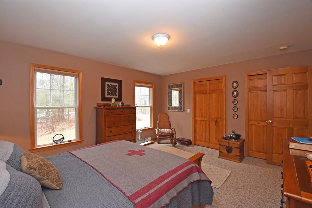 256 Glenwood Road Rutland, MA 01543 - Photo 13 of 30 a bedroom with a bed and large windows