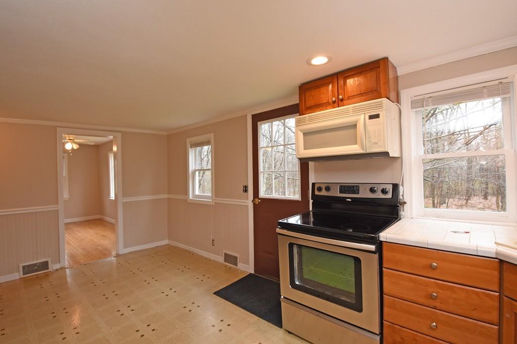 256 Glenwood Road Rutland, MA 01543 - Photo 19 of 30 a kitchen with a stove and a microwave