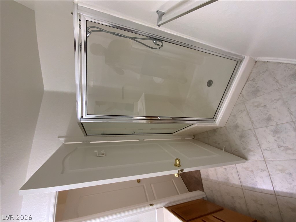 7400 West Flamingo Road, Unit 1039 Las Vegas, NV 89147 - Photo 29 of 40 A well-maintained shower with glass doors and tile flooring offers a refreshed daily routine.