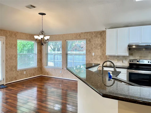 a kitchen with a sink and a large window