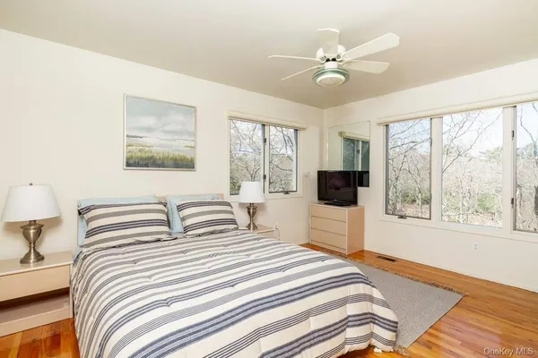 a bedroom with a large bed and a large window
