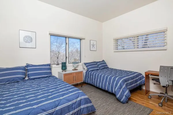 a bedroom with two beds and a dresser