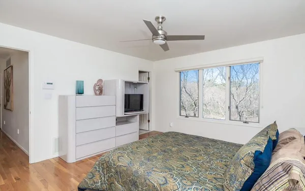 a bedroom with a bed and a window