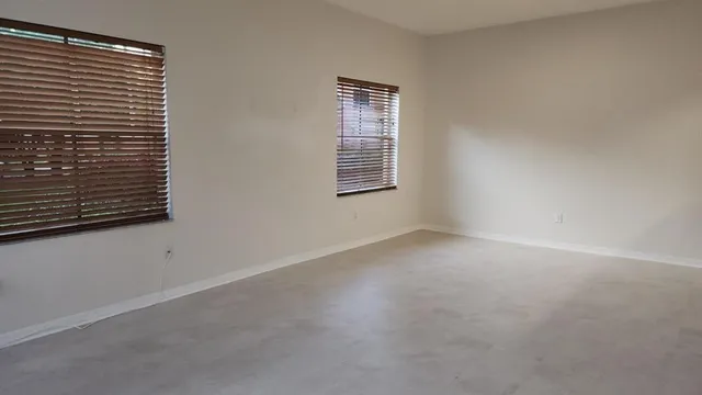 a view of empty room with windows