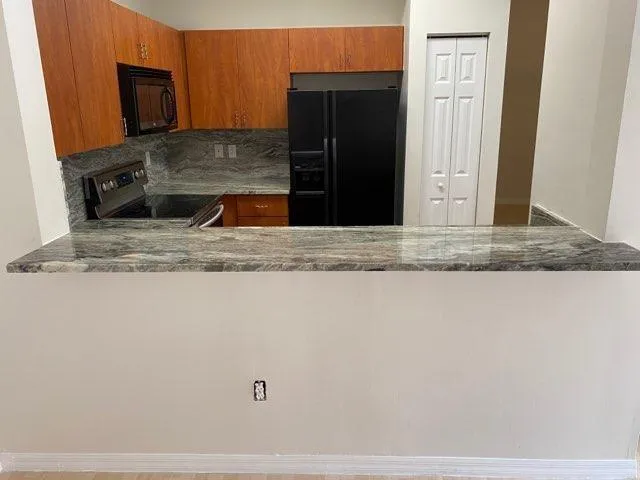 a kitchen with a refrigerator and a microwave