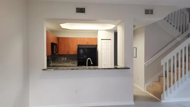 a view of a hallway with a kitchen