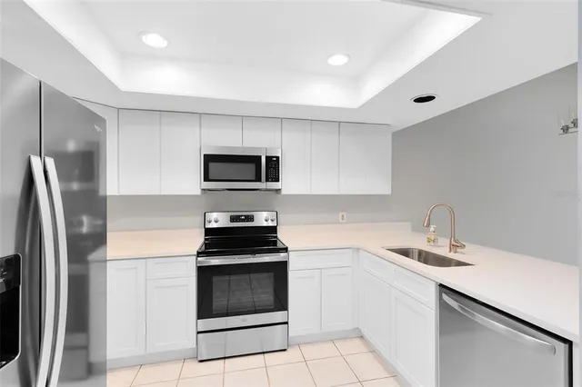 a kitchen with a sink stainless steel appliances and cabinets