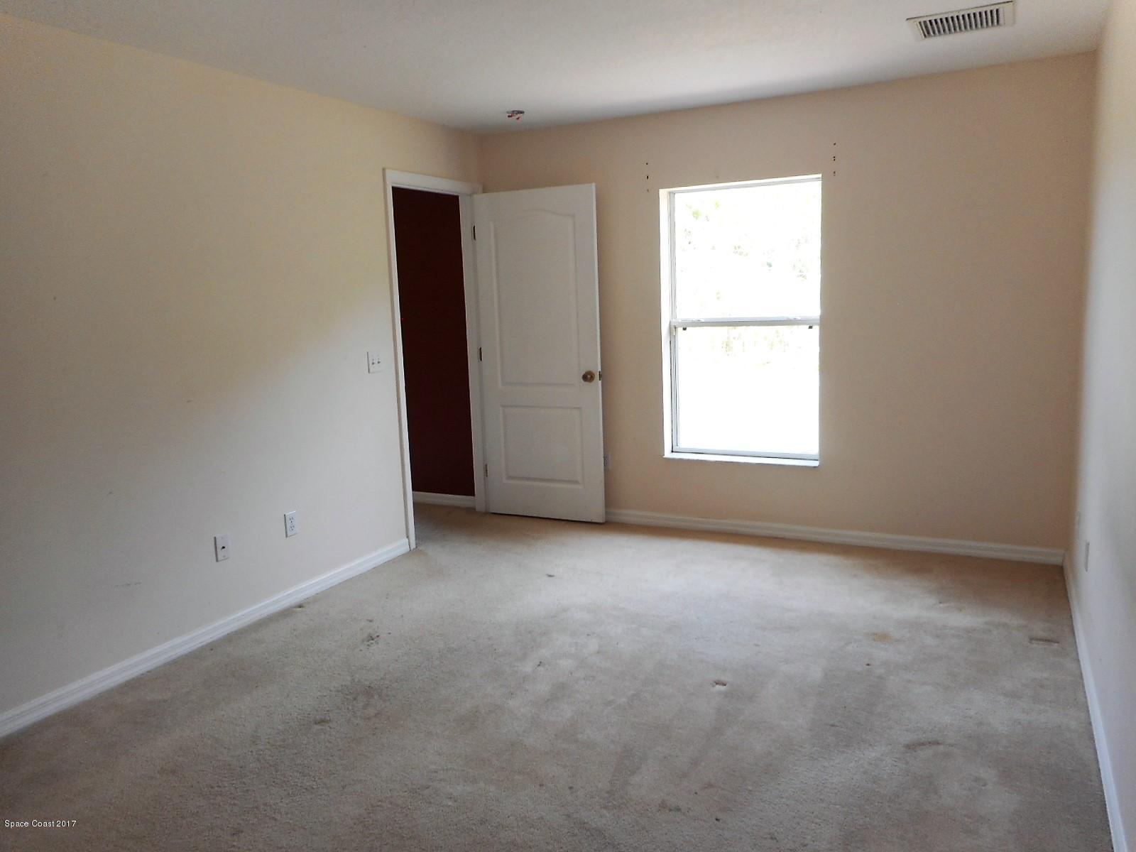 2174 Watkins Road Southeast Palm Bay, FL 32909 - Photo 7 of 13 Master bedroom