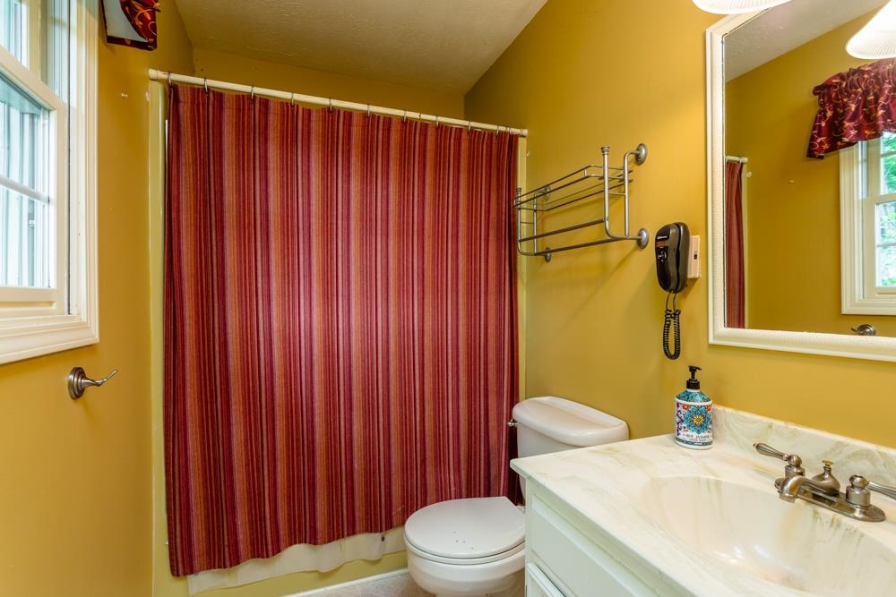 87 Bluestone Drive Weyers Cave, VA 24486 - Photo 14 of 37 a bathroom with a sink a toilet and shower curtain