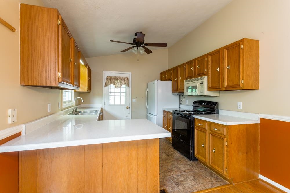 87 Bluestone Drive Weyers Cave, VA 24486 - Photo 4 of 37 a kitchen with stainless steel appliances granite countertop a sink a stove and a refrigerator