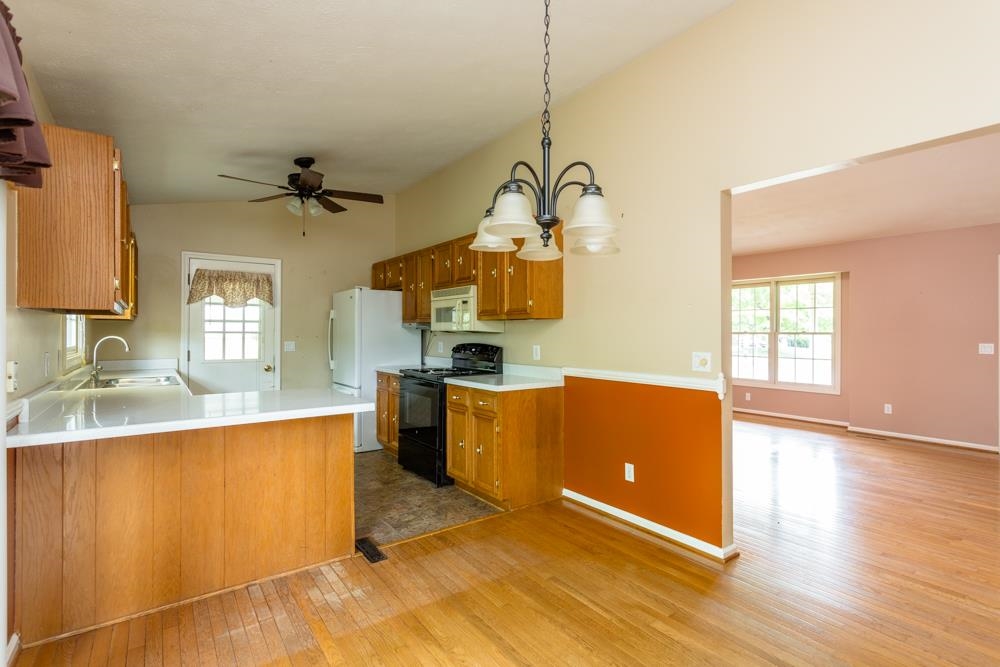 87 Bluestone Drive Weyers Cave, VA 24486 - Photo 6 of 37 a kitchen with stainless steel appliances granite countertop a sink a stove top oven a counter space and cabinets