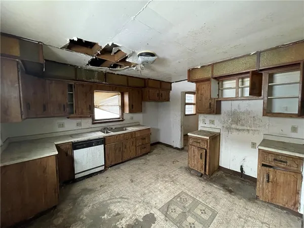 a kitchen with granite countertop a sink stove and cabinets