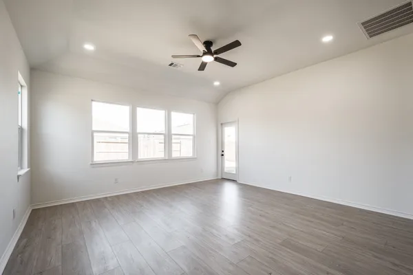 a view of kitchen with stainless steel appliances refrigerator stove microwave and cabinets
