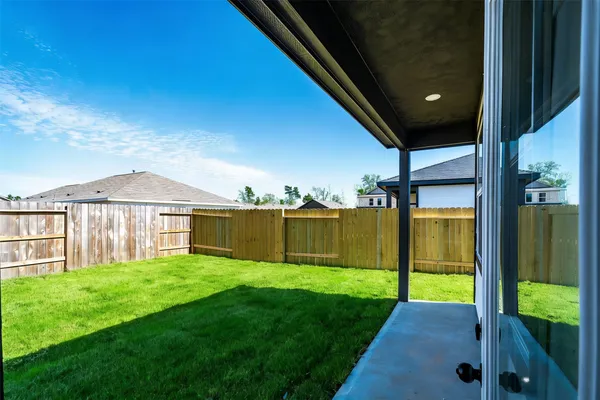 a front view of a house with yard and green space