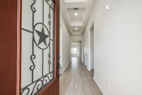a view of a hallway with wooden floor