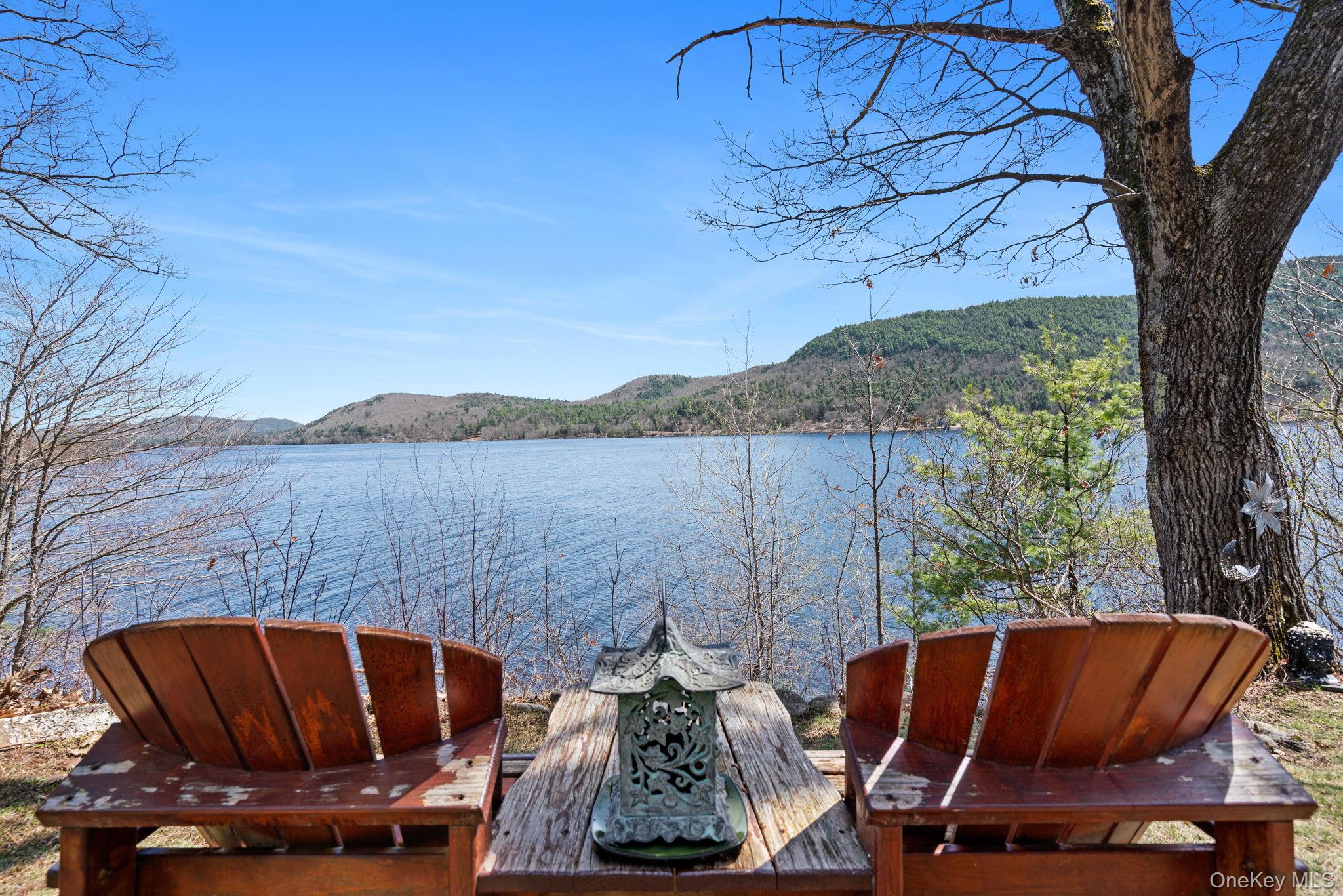 866 North Shore Road Hadley, NY 12835 - Photo 14 of 50 Expansive waterfront setting with serene lake and mountain backdrop.