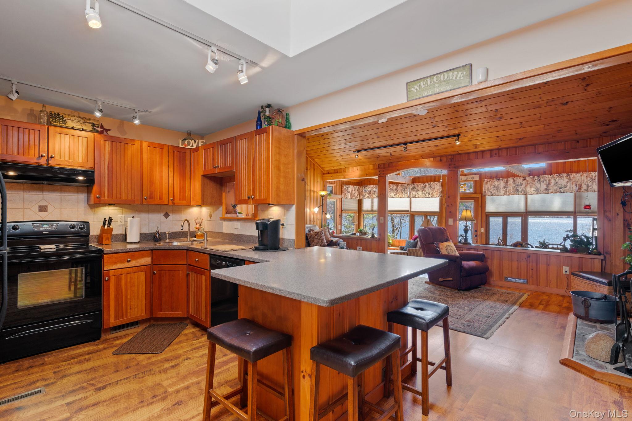 866 North Shore Road Hadley, NY 12835 - Photo 16 of 50 Kitchen is wide open to the entertainment area and provides lake views as well as an island.