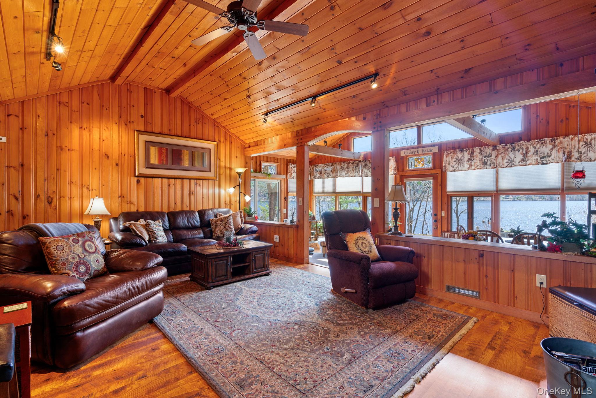 866 North Shore Road Hadley, NY 12835 - Photo 22 of 50 Living room with vaulted ceilings and quintessential cabin charm.
