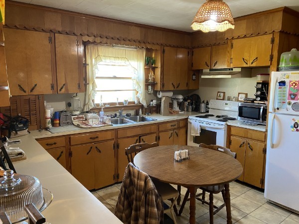 66 Union Hill Road Loretto, TN 38469 - Photo 19 of 31 a kitchen with stainless steel appliances granite countertop a sink a stove a kitchen island with chairs and wooden floor