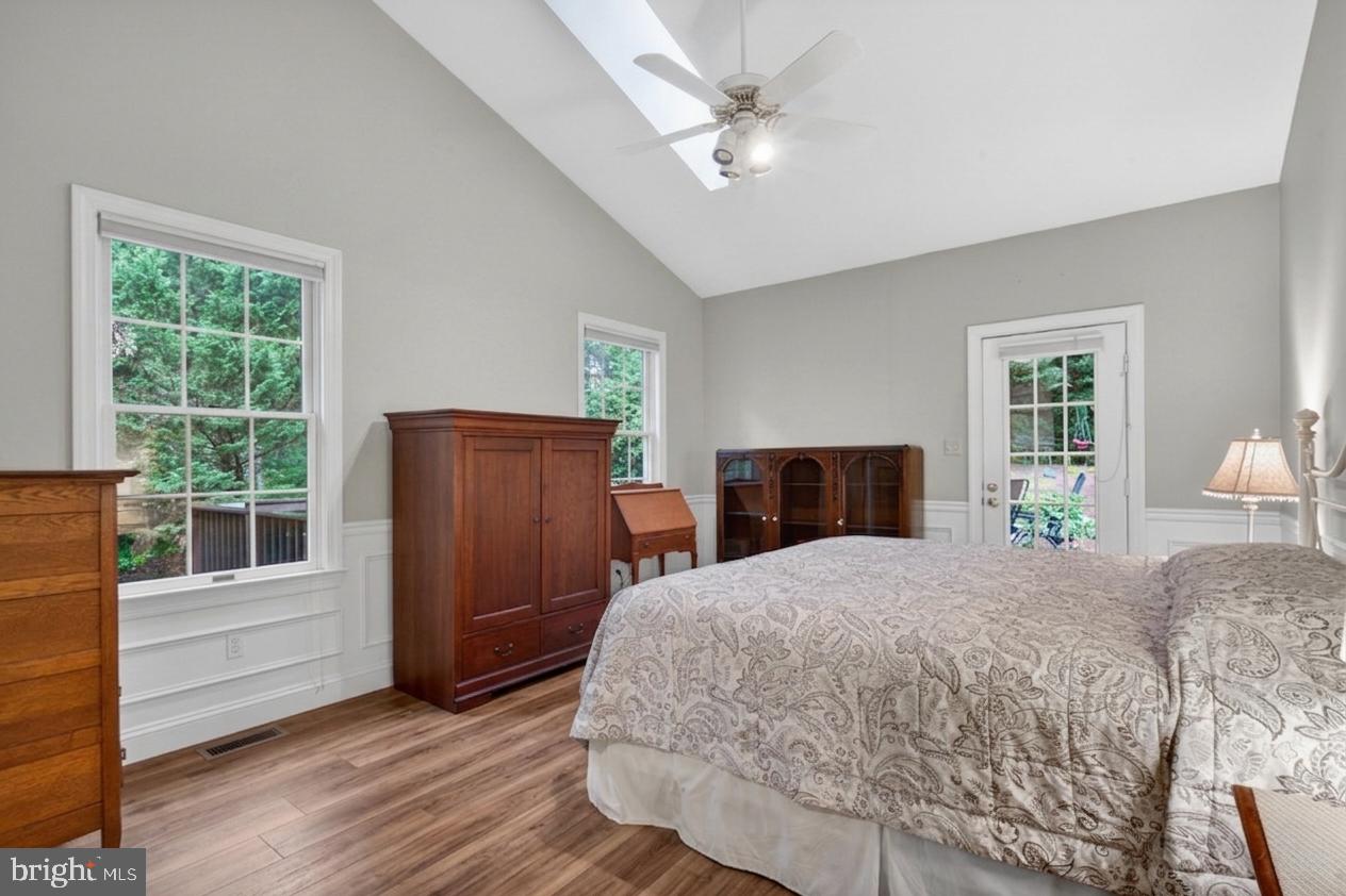 6601 Colchester Road Fairfax Station, VA 22039 - Photo 40 of 78 a bedroom with a bed and wooden floor