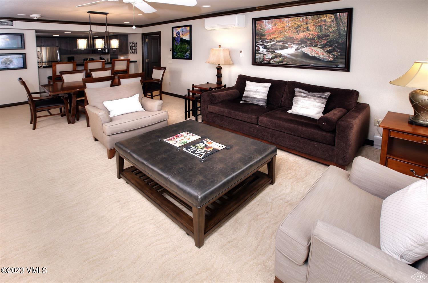 210 Offerson Road, Unit 10937 38 Beaver Creek, CO 81620 - Photo 3 of 9 a living room with furniture a rug and a wall painting