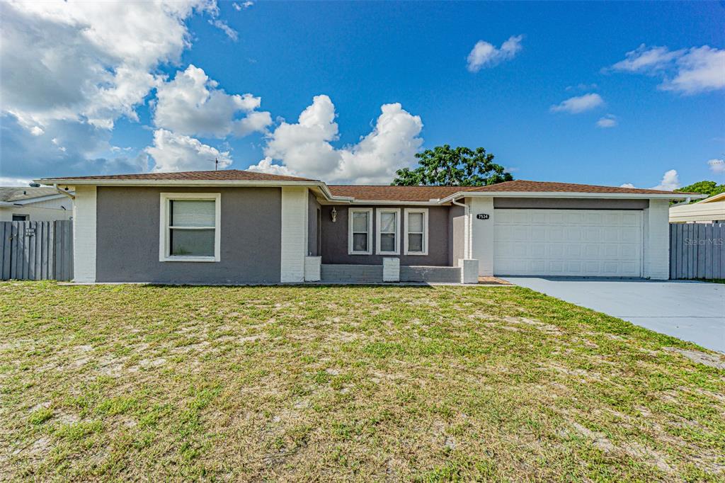 7534 Ironbark Drive Port Richey, FL 34668 - Photo 1 of 1 a view of a house with a outdoor space and balcony