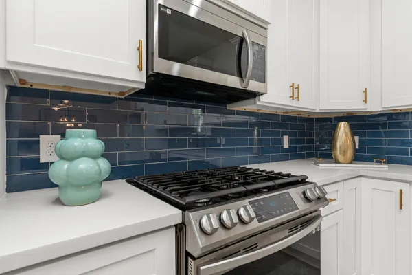 a kitchen with a stove and a microwave