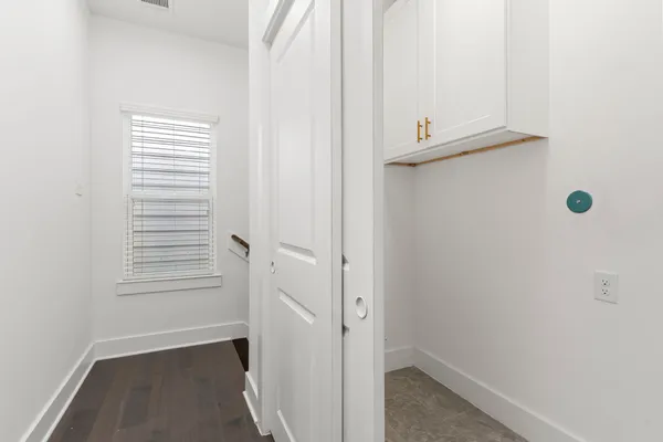 an empty room with a window and a ceiling fan