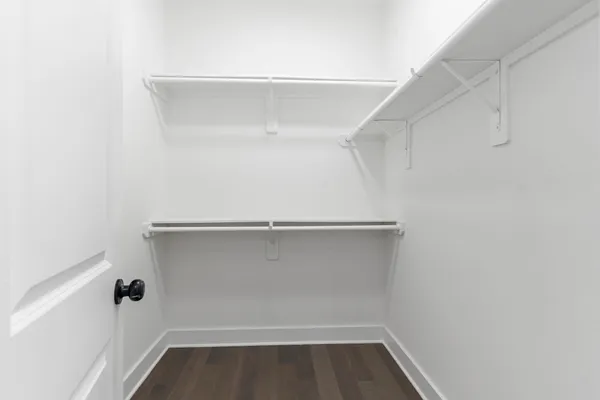 a bedroom with a bed and a ceiling fan