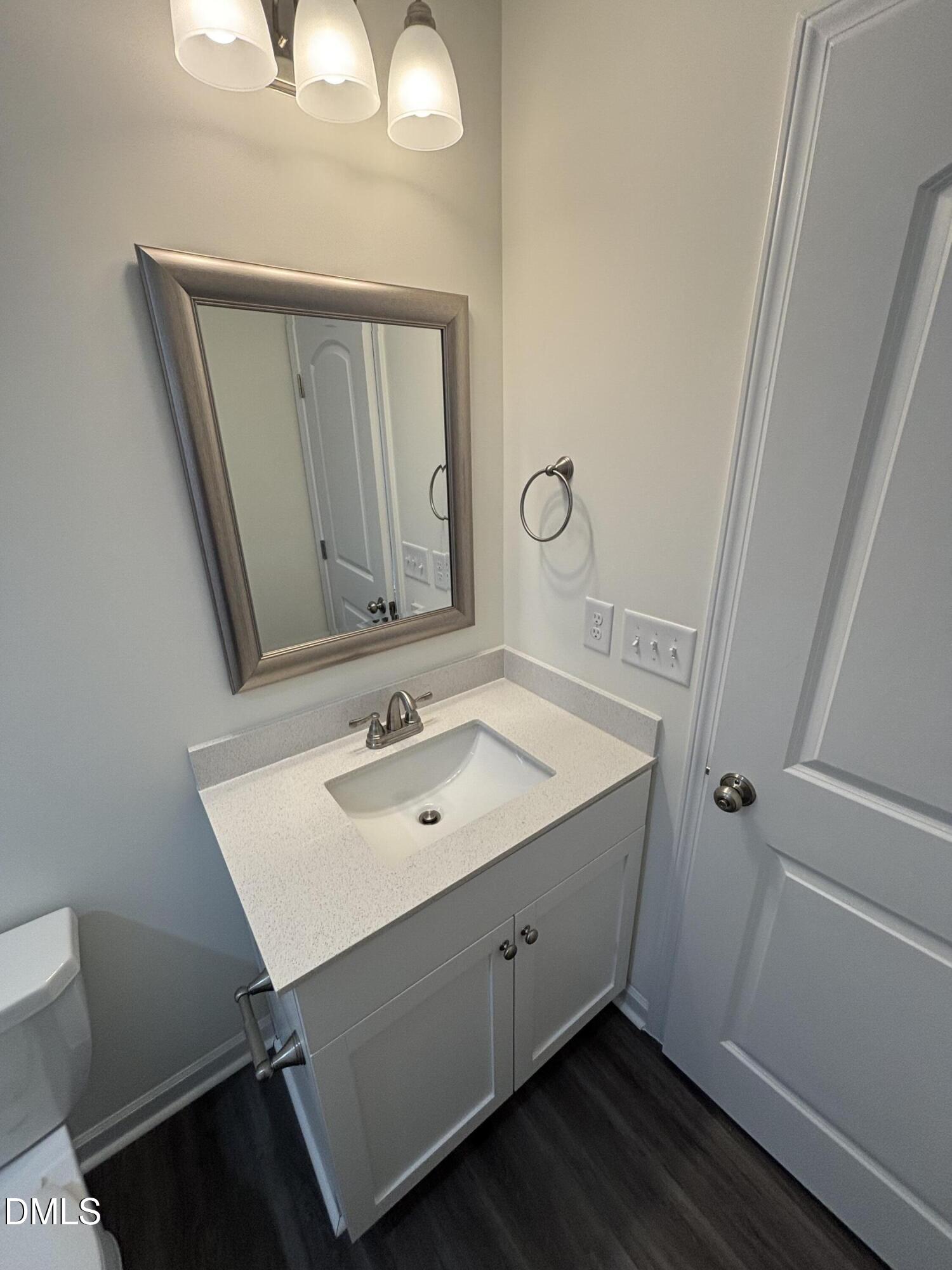 606 South Blackmon Street Benson, NC 27504 - Photo 21 of 25 a bathroom with a sink and a mirror