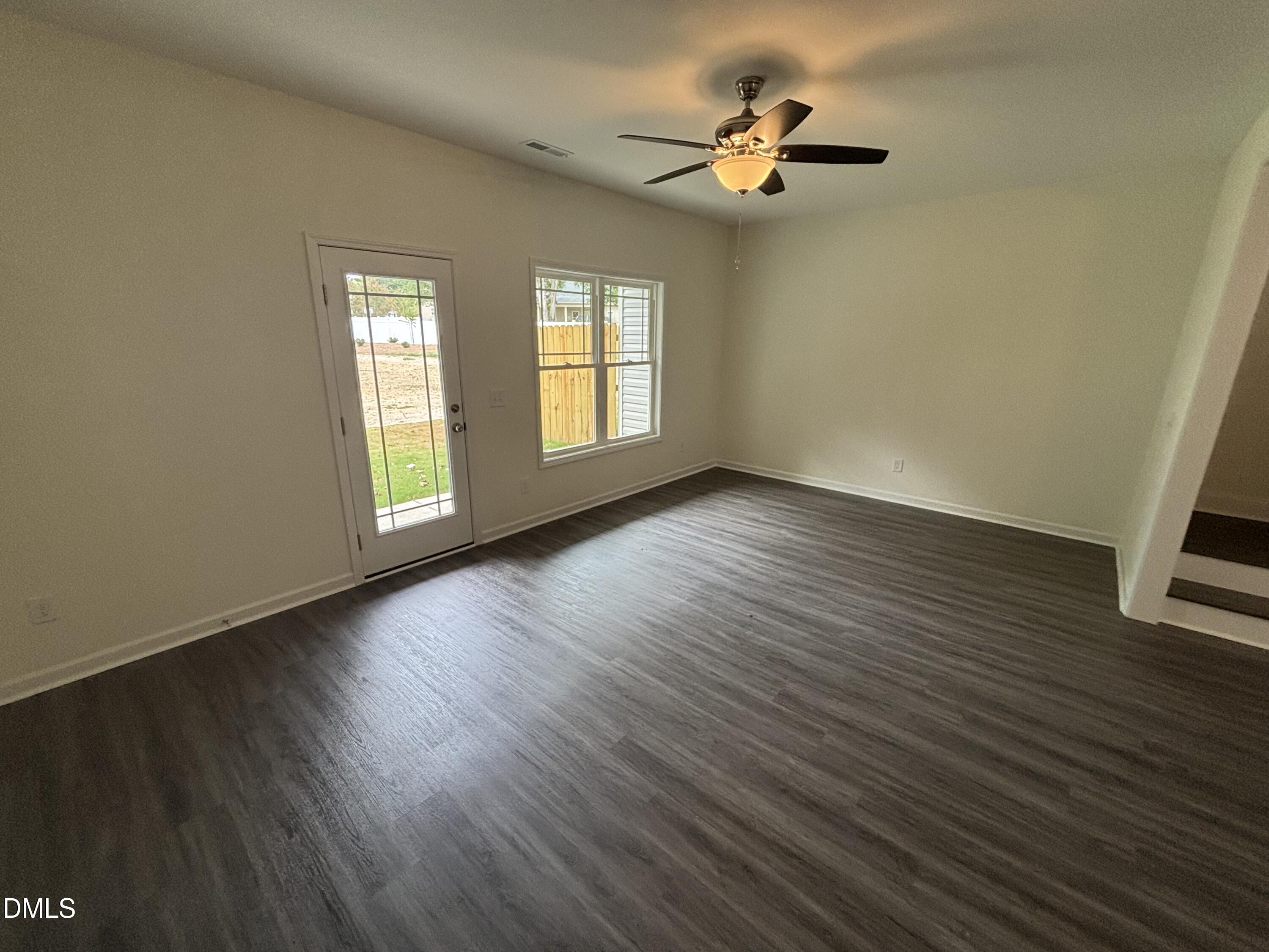 606 South Blackmon Street Benson, NC 27504 - Photo 22 of 25 a view of an empty room with a window and wooden floor