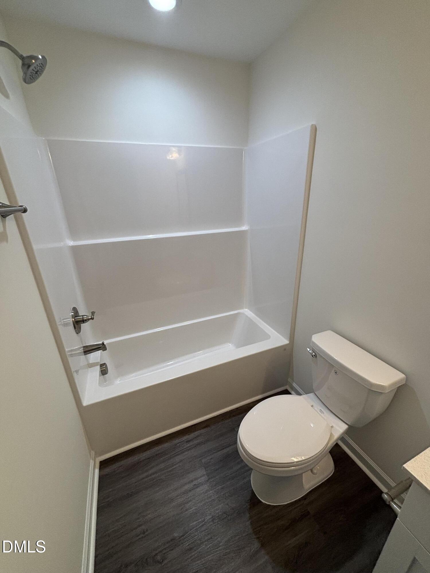 606 South Blackmon Street Benson, NC 27504 - Photo 23 of 25 a white toilet sitting next to a bath tub