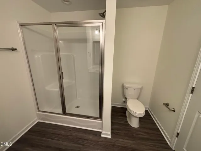 a bathroom with a toilet and a shower