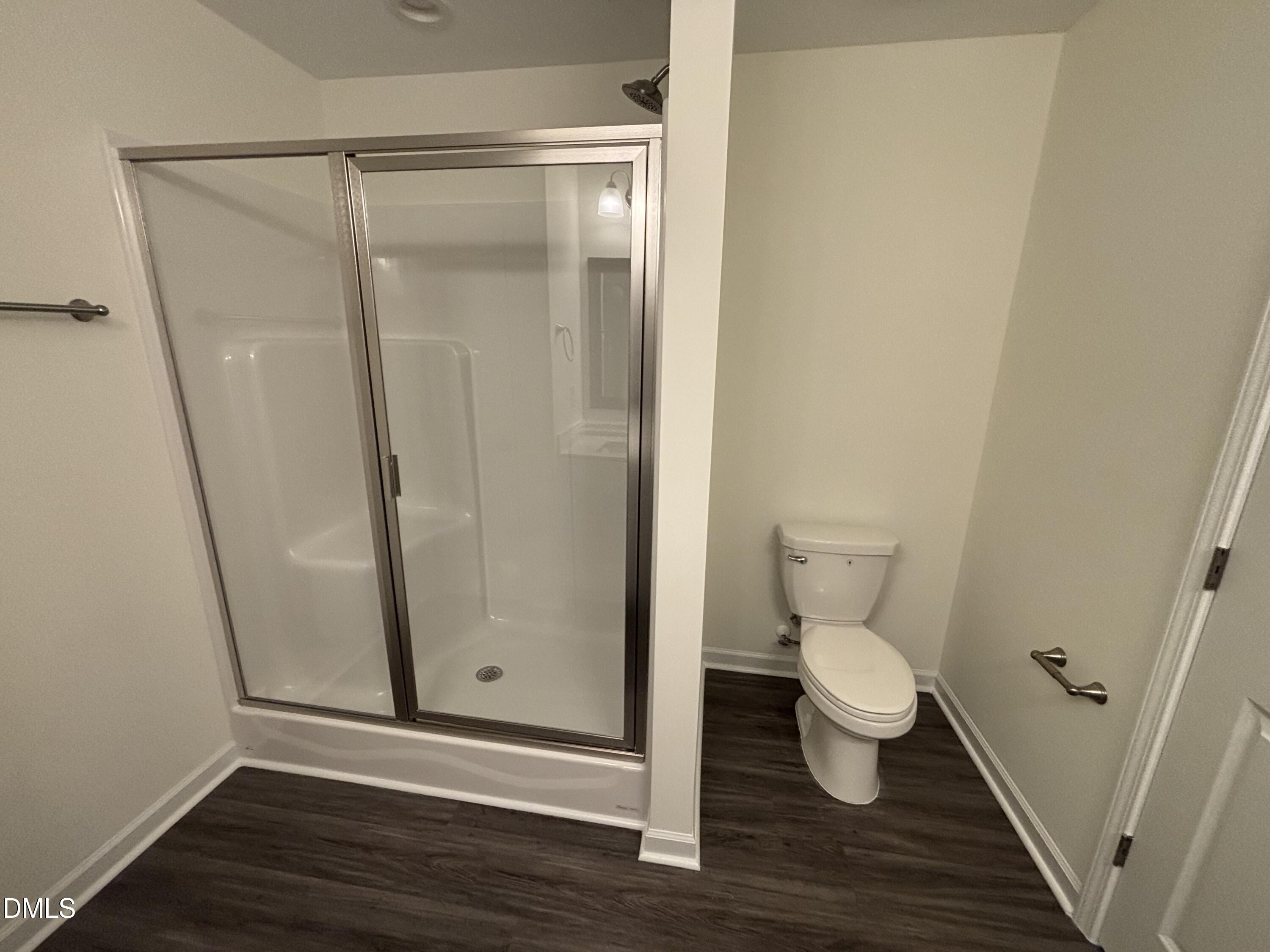 606 South Blackmon Street Benson, NC 27504 - Photo 10 of 25 a bathroom with a toilet and a shower