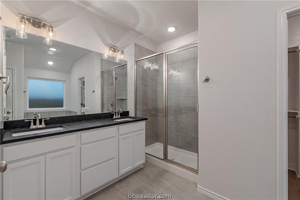 3161 Tarleton Court Bryan, TX 77808 - Photo 17 of 23 a bathroom with double sink and a mirror
